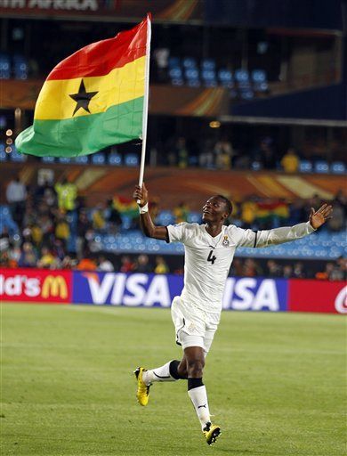 Holding Ghana flag after victory
